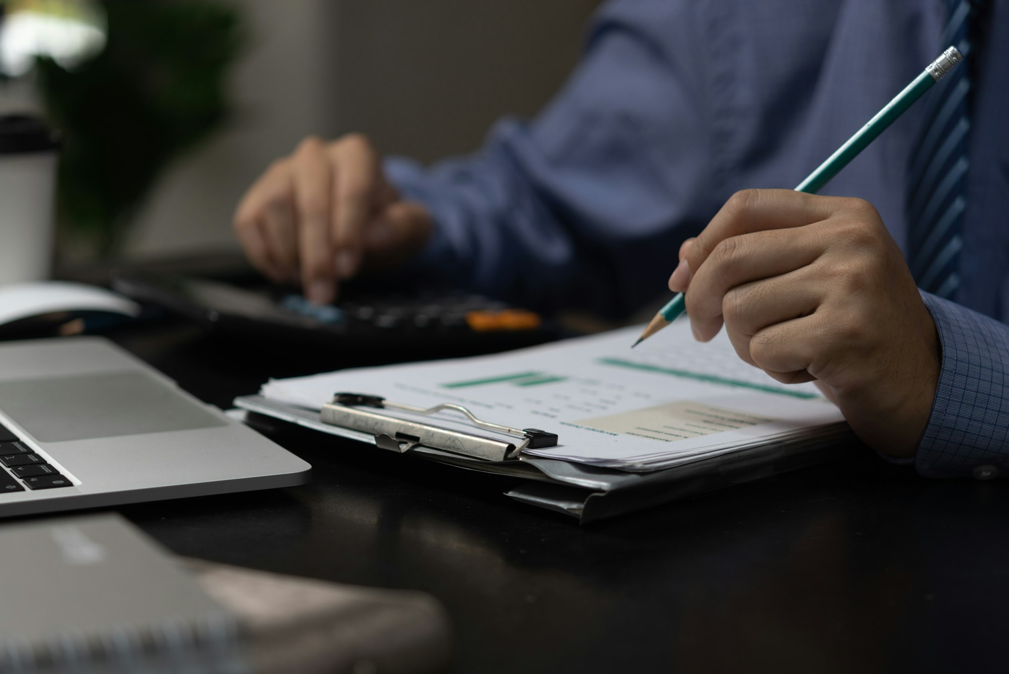 Businessman analyze marketing plan investment graph and financial chart growth management on desk.