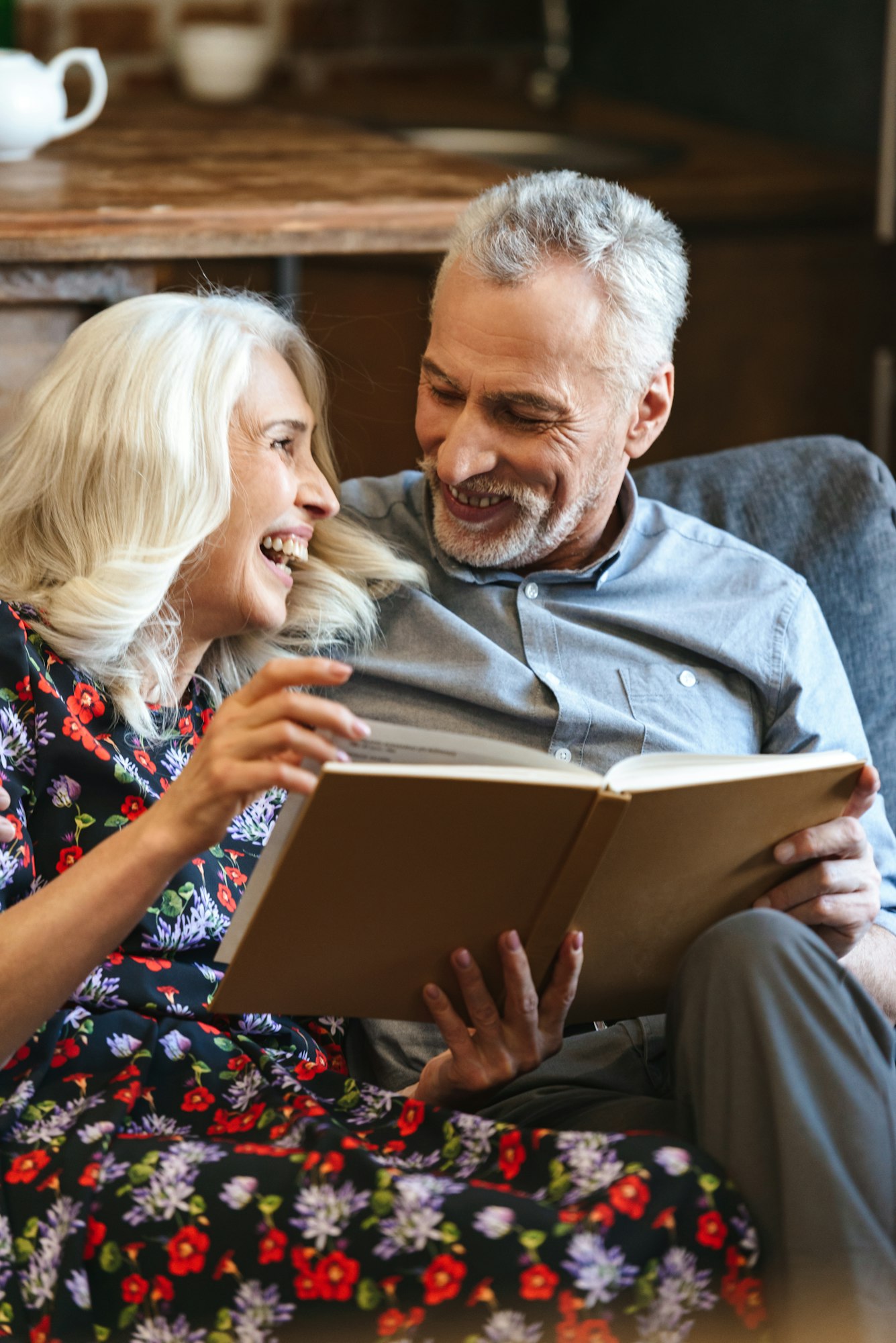 Portrait of lovely old couple 60s resting together at cozy home,